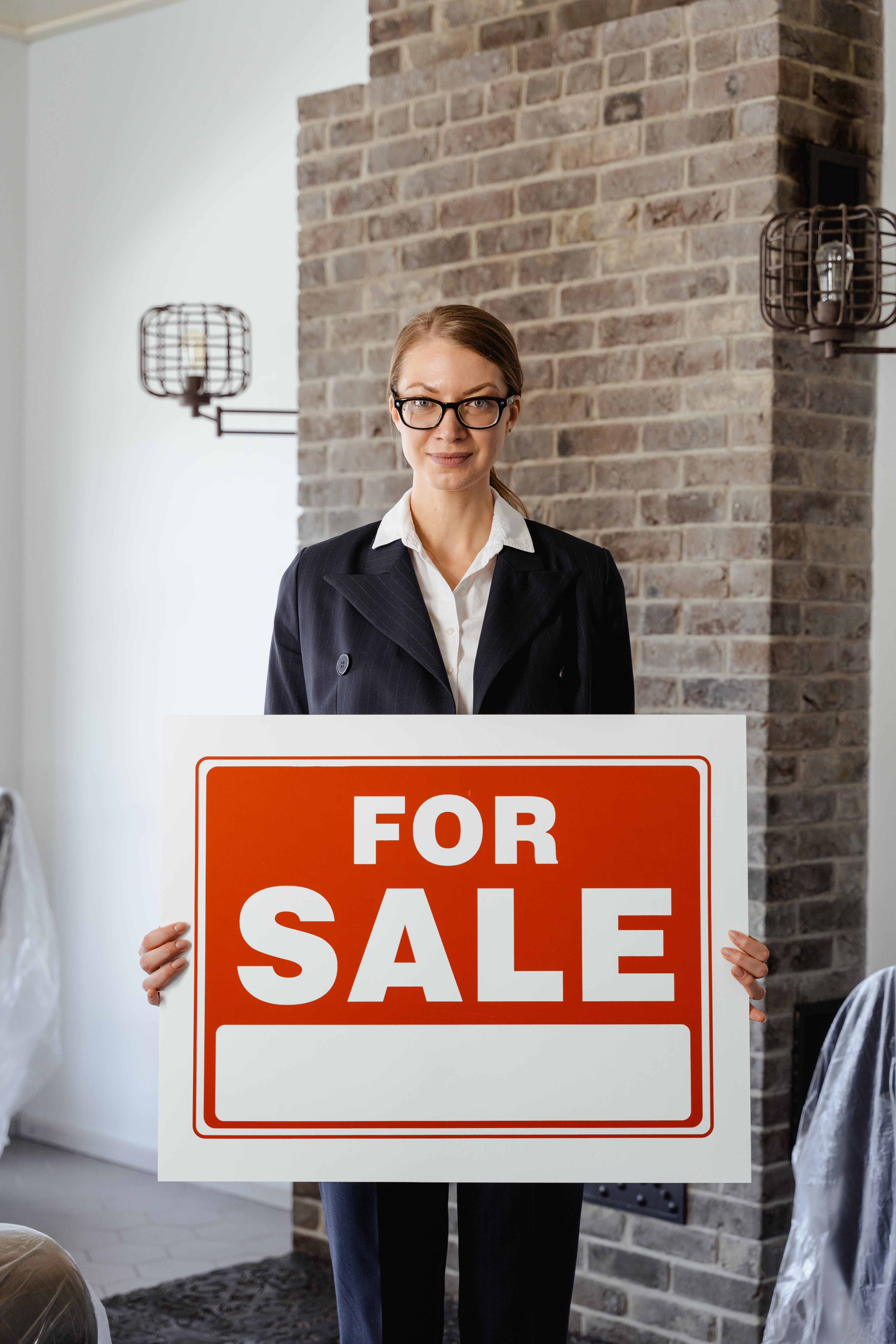 realtor holding for sale sign